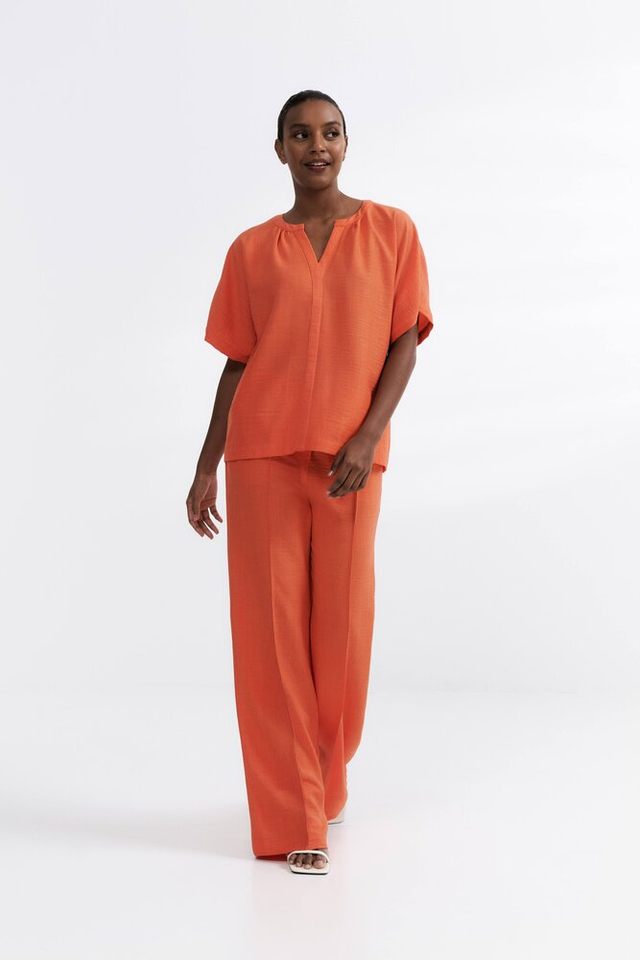 Oranje broek met plooi vooraan Her